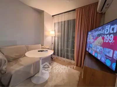 Cozy living room with modern TV setup and stylish furniture in a contemporary apartment.