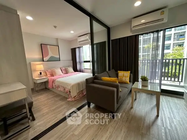 Modern bedroom with stylish decor and balcony view in urban apartment.