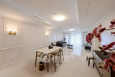 Elegant open-plan living and dining area with modern decor and ample natural light.