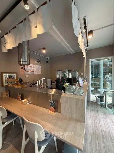 Chic modern kitchen with open layout and sleek wooden finishes, perfect for culinary enthusiasts.