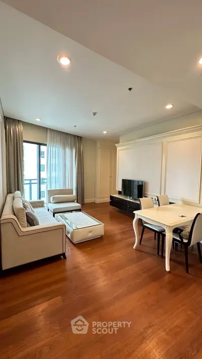Spacious living room with elegant furniture and large window view