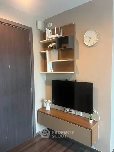 Modern living room with wall-mounted TV and stylish shelving unit