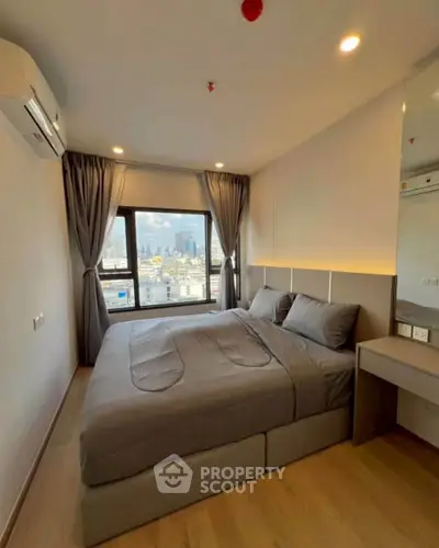 Modern bedroom with city view, featuring sleek design and natural light, perfect for urban living.