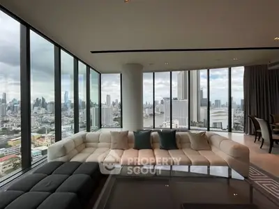 Luxurious corner unit living room with panoramic city views and modern furnishings.