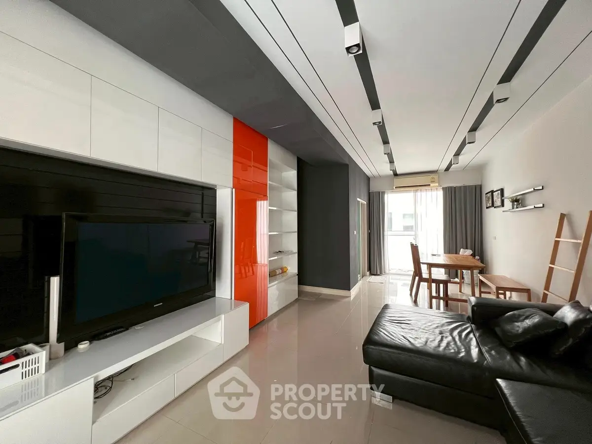 Modern living room with sleek design and large TV unit