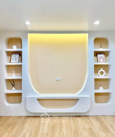 Modern living room with stylish built-in shelves and warm lighting