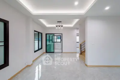 Spacious modern living room with elegant lighting and large windows