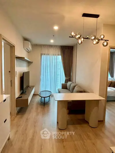 Modern living room with stylish lighting and cozy seating area in a contemporary apartment.