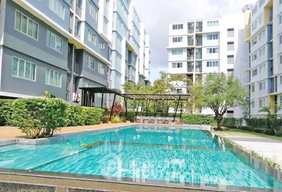 Modern apartment complex with a stunning outdoor pool and lush greenery, perfect for relaxation and leisure.