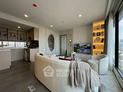 Luxurious modern living room with open kitchen and city view, featuring elegant decor and cozy seating.