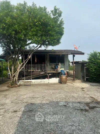 Charming rustic house with lush greenery and spacious outdoor area.