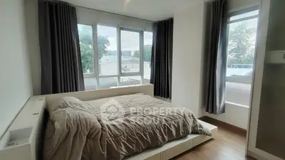 Spacious bedroom with large windows and modern decor