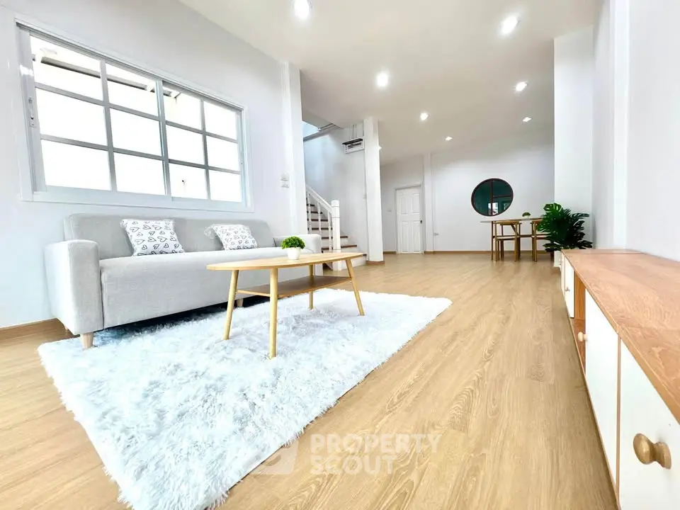 Spacious modern living room with cozy decor and natural light