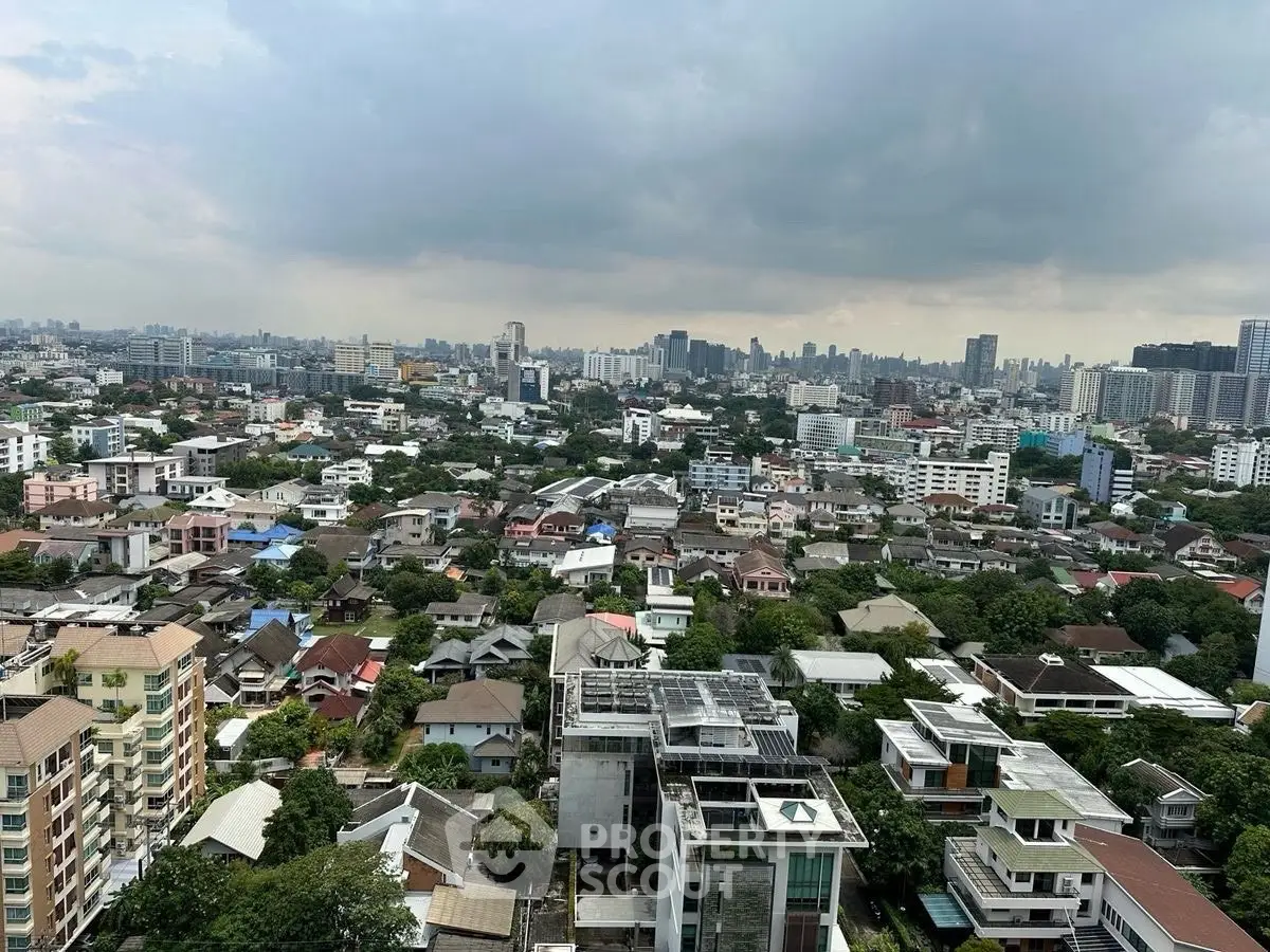 Stunning cityscape view showcasing diverse architecture and lush greenery from a high vantage point.