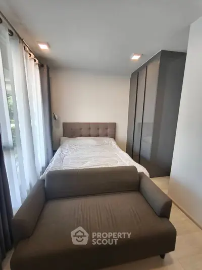 Cozy bedroom with modern furnishings and ample natural light