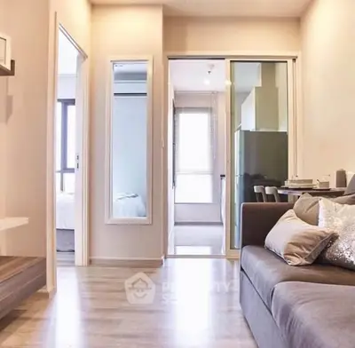 Modern apartment interior with cozy living room and sleek kitchen design.