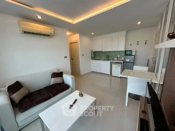Modern open-layout living room with sleek kitchen and stylish decor