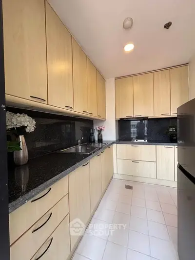 Modern kitchen with sleek cabinetry and granite countertops