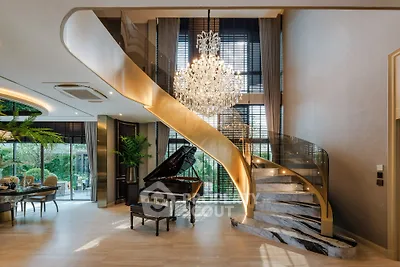 Luxurious living room with grand piano and elegant spiral staircase