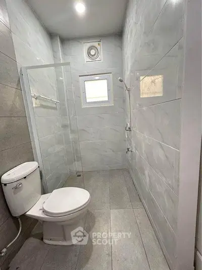 Modern bathroom with sleek tiles and compact design