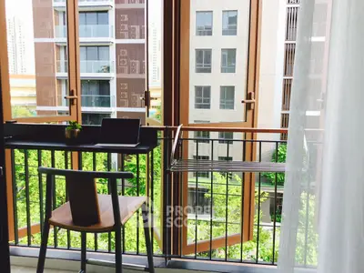Modern balcony with urban view and stylish furniture, perfect for relaxation and work-from-home setup.