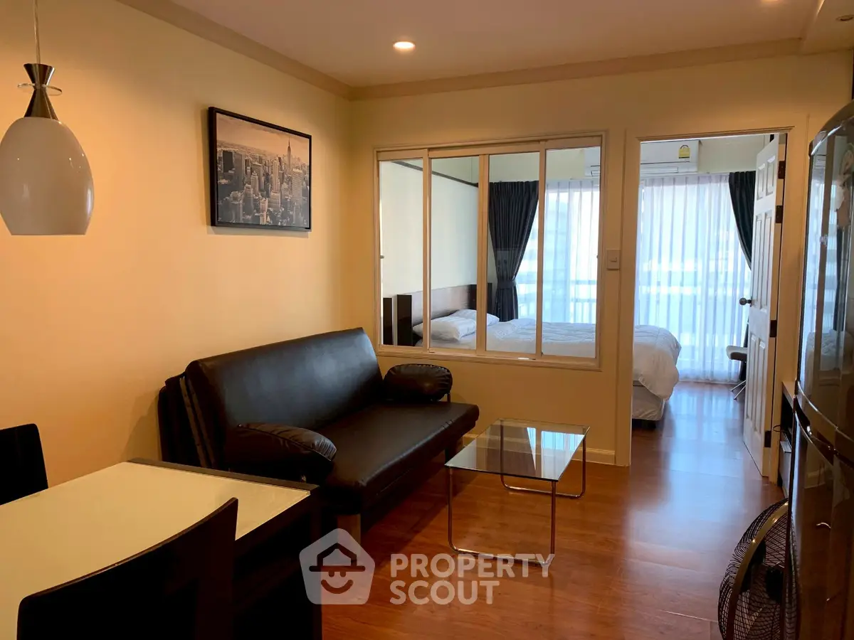 Modern apartment interior with cozy living room and bedroom, featuring stylish furniture and warm lighting.