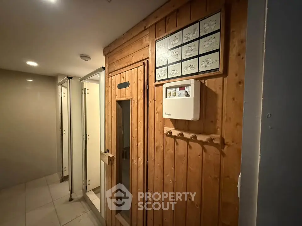 Luxurious sauna room in modern building with wooden paneling and sleek design.