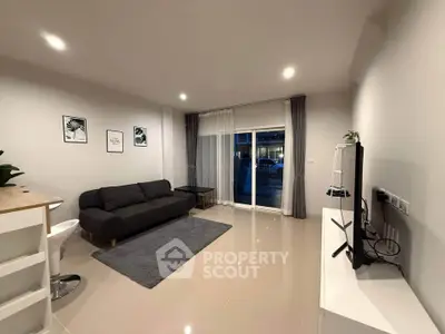 Modern living room with sleek furniture and large window for natural light.