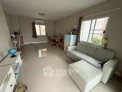 Spacious living room with modern furniture and natural light, perfect for family gatherings.