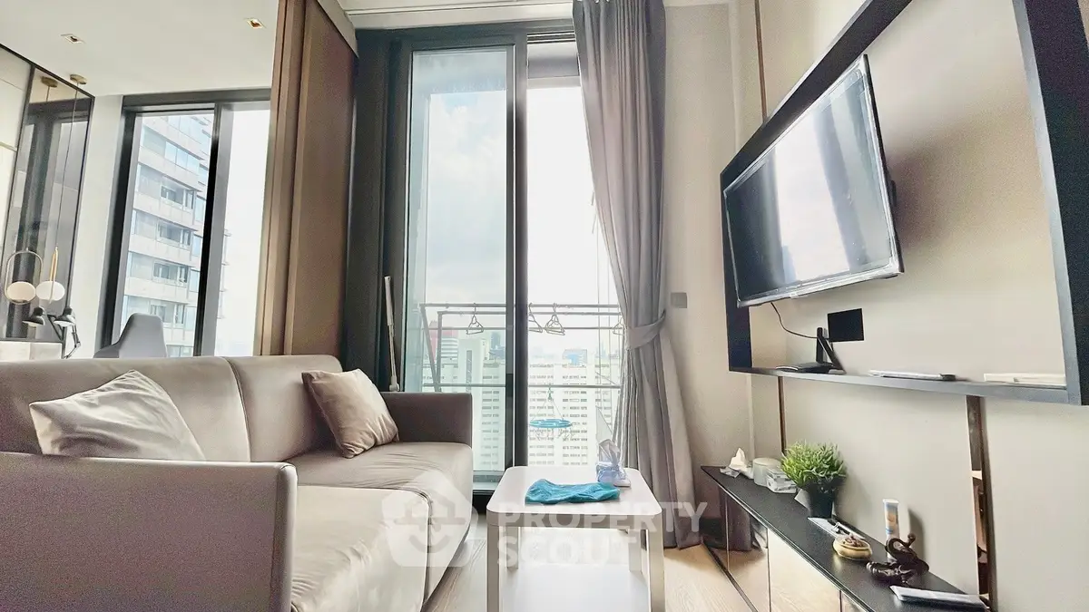 Modern living room with city view, sleek furniture, and large windows for natural light.