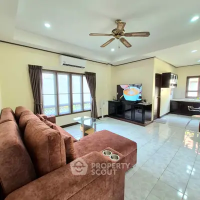 Spacious living room with modern furniture and open kitchen layout