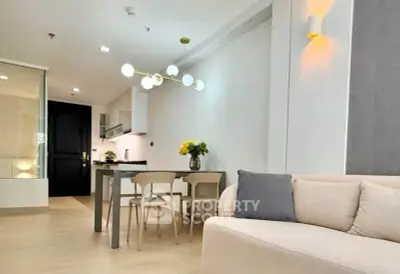 Modern open-layout living room with dining area and stylish lighting in a contemporary apartment.