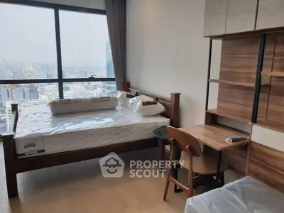 Modern bedroom with city view, featuring wooden furniture and large window, perfect for urban living.