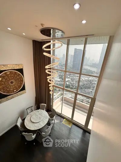 Luxurious high-rise living room with stunning city view and elegant chandelier