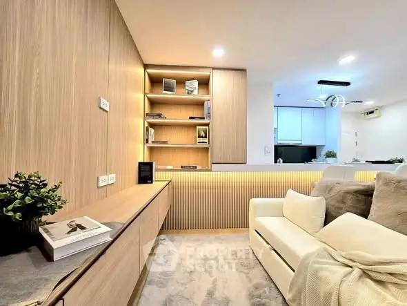 Modern living room with stylish wooden paneling and cozy sofa in open layout apartment.