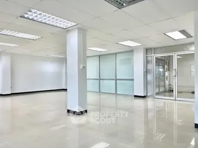 Spacious modern office space with bright lighting and glass partitions