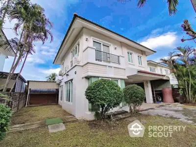 Charming two-story house with lush garden and spacious driveway in serene neighborhood.