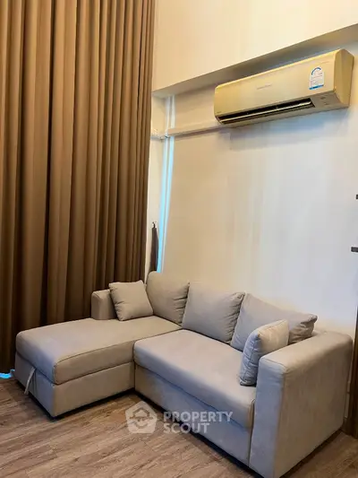 Modern living room with cozy sectional sofa and air conditioning