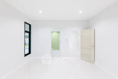 Spacious modern interior with white walls and sleek design, featuring a bright open layout.