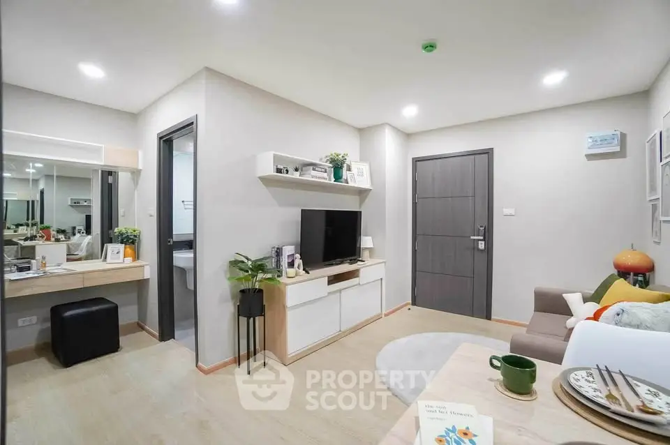 Modern living room with stylish decor and entertainment center in a cozy apartment.