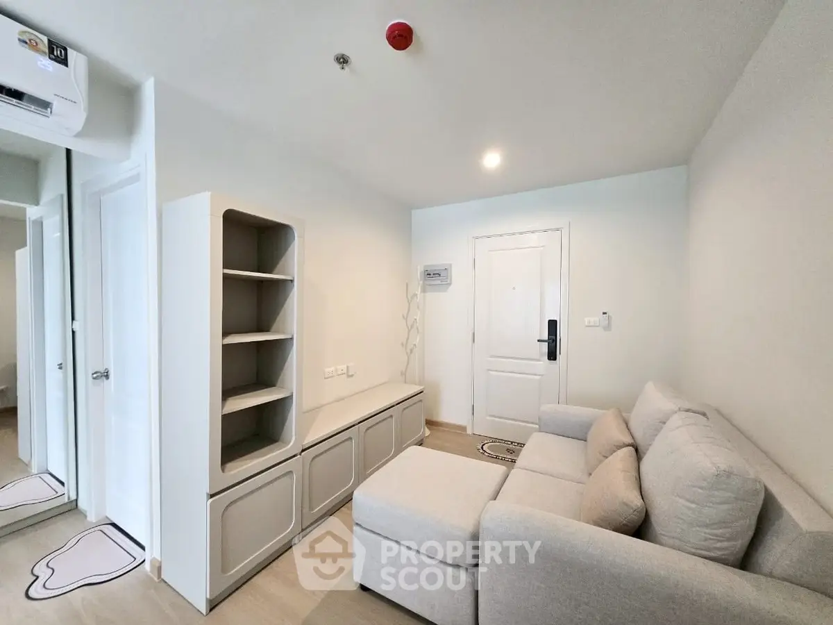 Modern living room with cozy sofa and stylish shelving in a bright apartment.