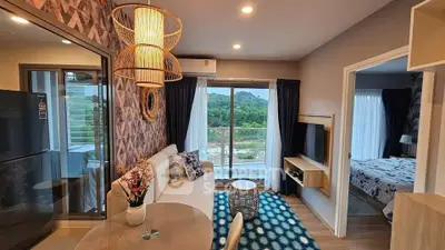 Modern living room with stylish decor and balcony view