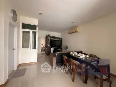 Spacious living room with dining area and modern decor in a stylish apartment.