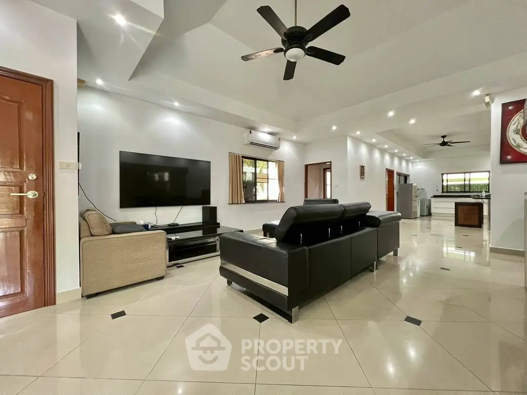 Spacious modern living room with sleek furniture and open layout, perfect for entertaining.