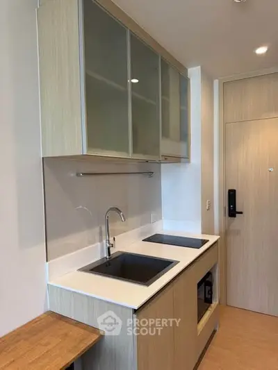 Modern kitchen with sleek cabinetry and built-in appliances in a stylish apartment.