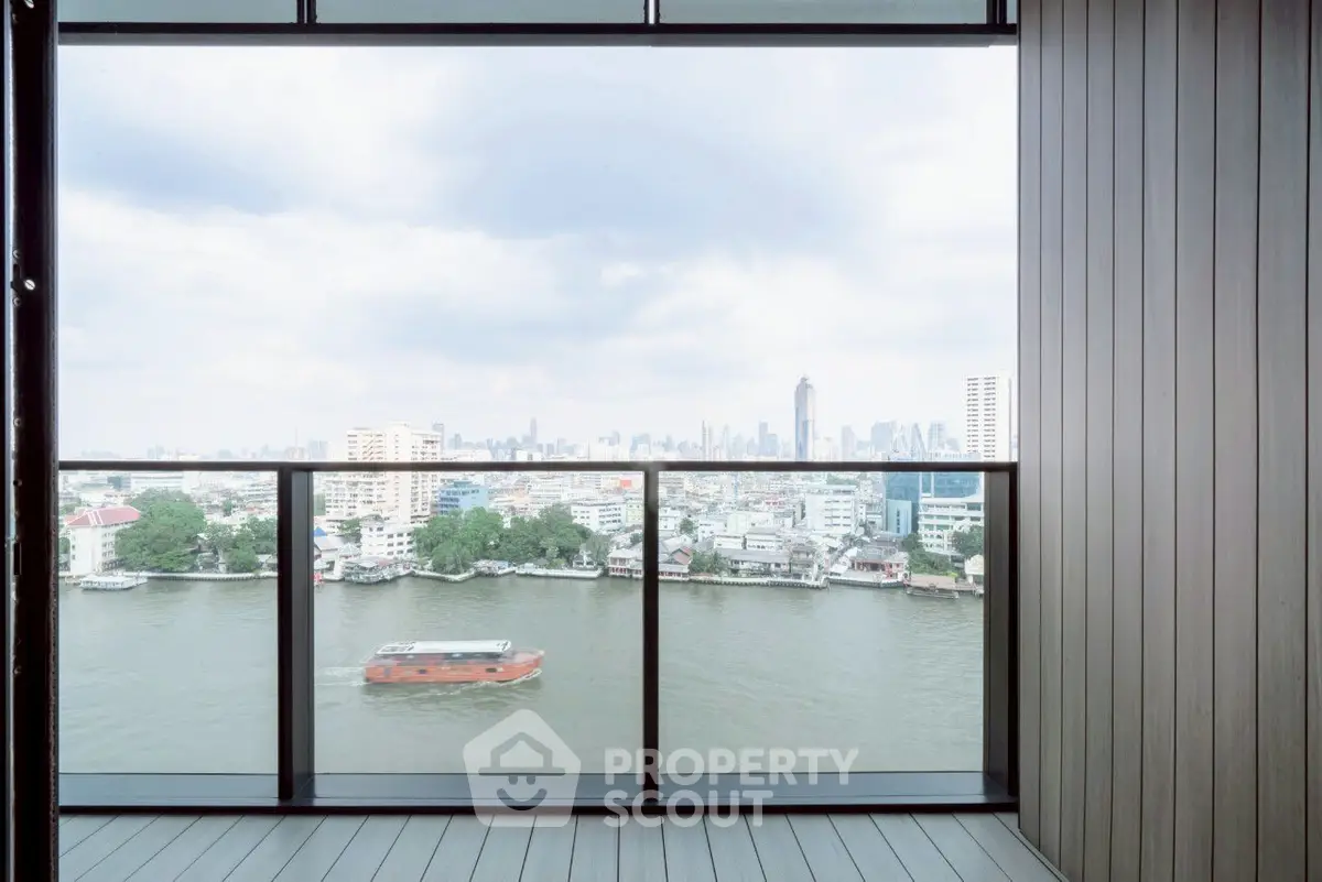 Stunning river view from a modern balcony with city skyline backdrop.