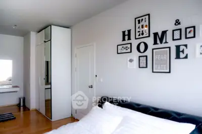 Modern bedroom with stylish decor and ample natural light, featuring a cozy bed and sleek storage solutions.