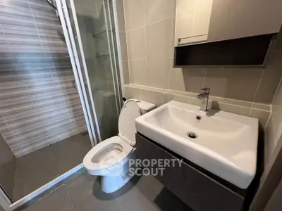 Modern bathroom with sleek fixtures and glass shower enclosure