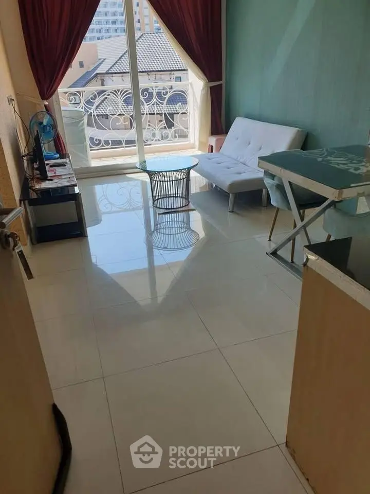 Charming living room with elegant balcony view and modern furnishings in a cozy apartment.