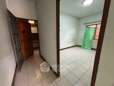 Spacious interior room with tiled flooring and natural light, ideal for customization.